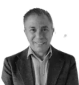 Headshot of a smiling middle-aged man wearing a dark blazer and light dress shirt against a white background
